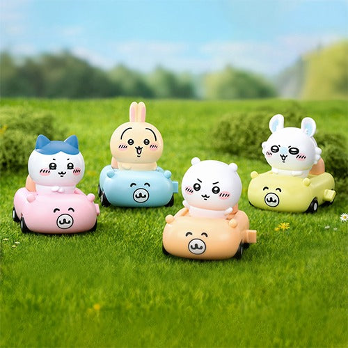 52TOYS Chiikawa Happy Drive Series blind box display showing Chiikawa, Hachiware, and Usagi driving colorful pull-back miniature cars with pink packaging.