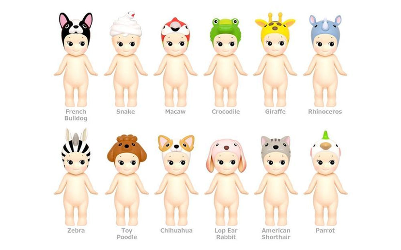 Row of baby dolls with animal headbands on a white background
