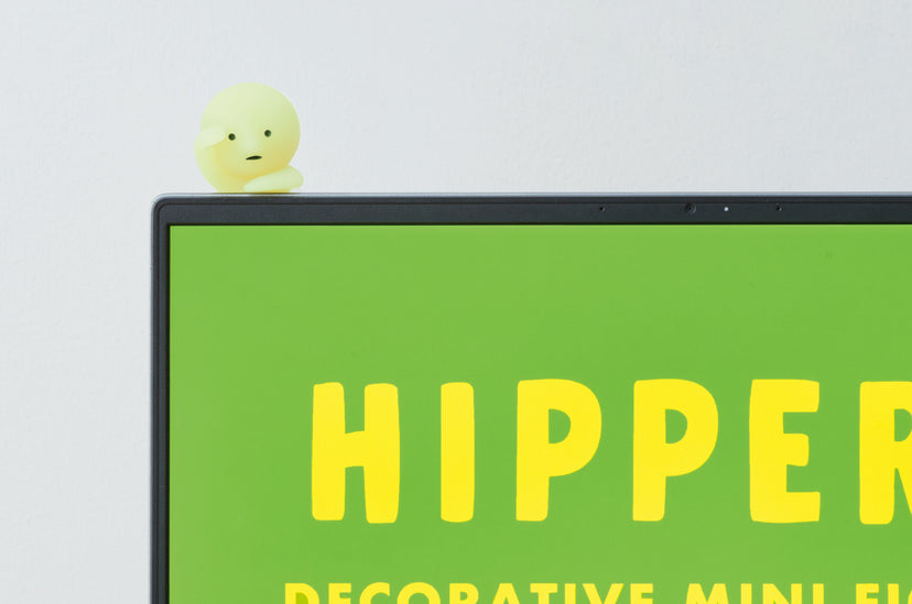 Dreams SMISKI HIPPERS decorative mini figures peeking from a smartphone, computer monitor, green mug, and photo frame on a lime green background.