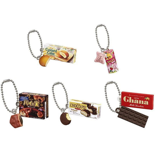 Bandai Lotte Mascot Charm 2025 Package Gashapon collection featuring miniature keychains of Custard Cake, Koala's March, Pai no Mi, Choco Pie, and Ghana Milk Chocolate.