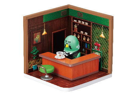 Toy set with a green character behind a desk in a room setting