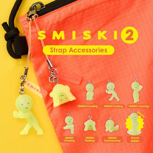 Smiski Strap Accessories Series 2 capsule toys with six glow-in-the-dark poses like climbing, kneeling, peeking, and a secret figure collectible.