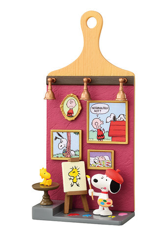 Snoopy art-themed decorative item with paintings and a paintbrush on a white background