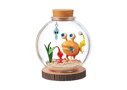 Decorative glass globe with cartoon-like characters on a white background