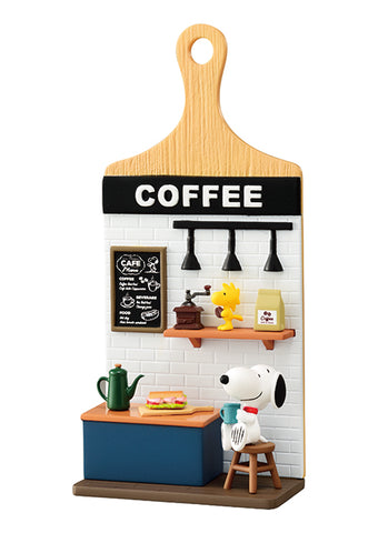 Model of a coffee-themed miniature setup with a wooden paddle labeled 'COFFEE'.