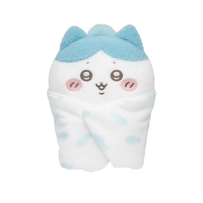 Plush toy with blue hair and a smiling face on a white background