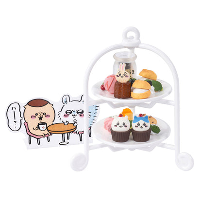 A collection of Chiikawa Cafe miniatures including Hachiware cream soda, character-themed curry, and a tiered afternoon tea stand on a pink background.