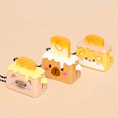 Bread Pops Up Toaster Keychain — miniature toaster bag charm with bread popping up, kawaii novelty keychain