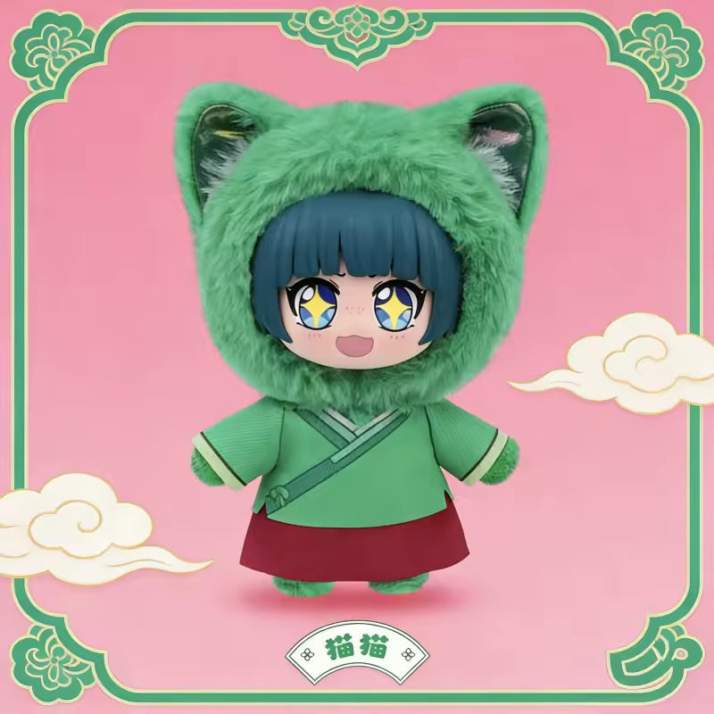 Plush toy with green hood and outfit on a pink background