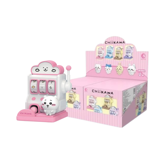 Small pink toy slot machine with a white cat figure inside, next to its packaging box on a white background.