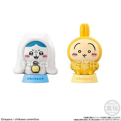 Two colorful figurines with cartoon-like faces on a white background, featuring the brand 'Chiiikawa'.