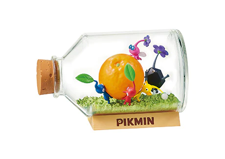 Glass bottle with a cork lid containing a miniature scene of Pikmin characters around an orange, on a white background.